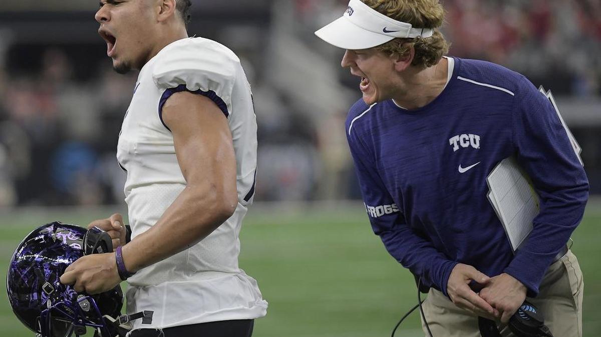 TCU quarterback Kenny Hill and co-offensive coordinator Sonny Cumbie react on the sideline after John Diarse’s catch in the end zone was ruled a touchdown during the second quarter of the Big 12 championship game Saturday at AT&T Stadium.
