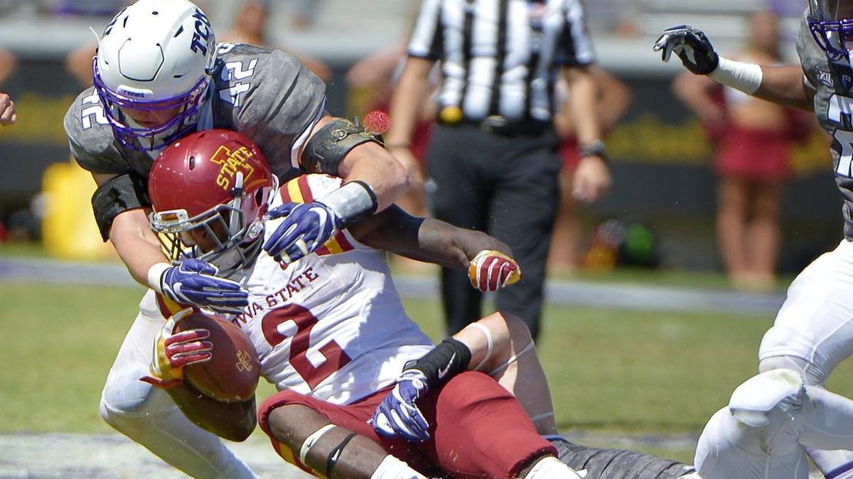 TCU linebacker Ty Summers (left) teams up with defensive end Mat Boesen for a tackle against Iowa state running back Mike Warren during third-quarter action last week at Amon G. Carter Stadium. Summers finished with a team-high 16 tackles.