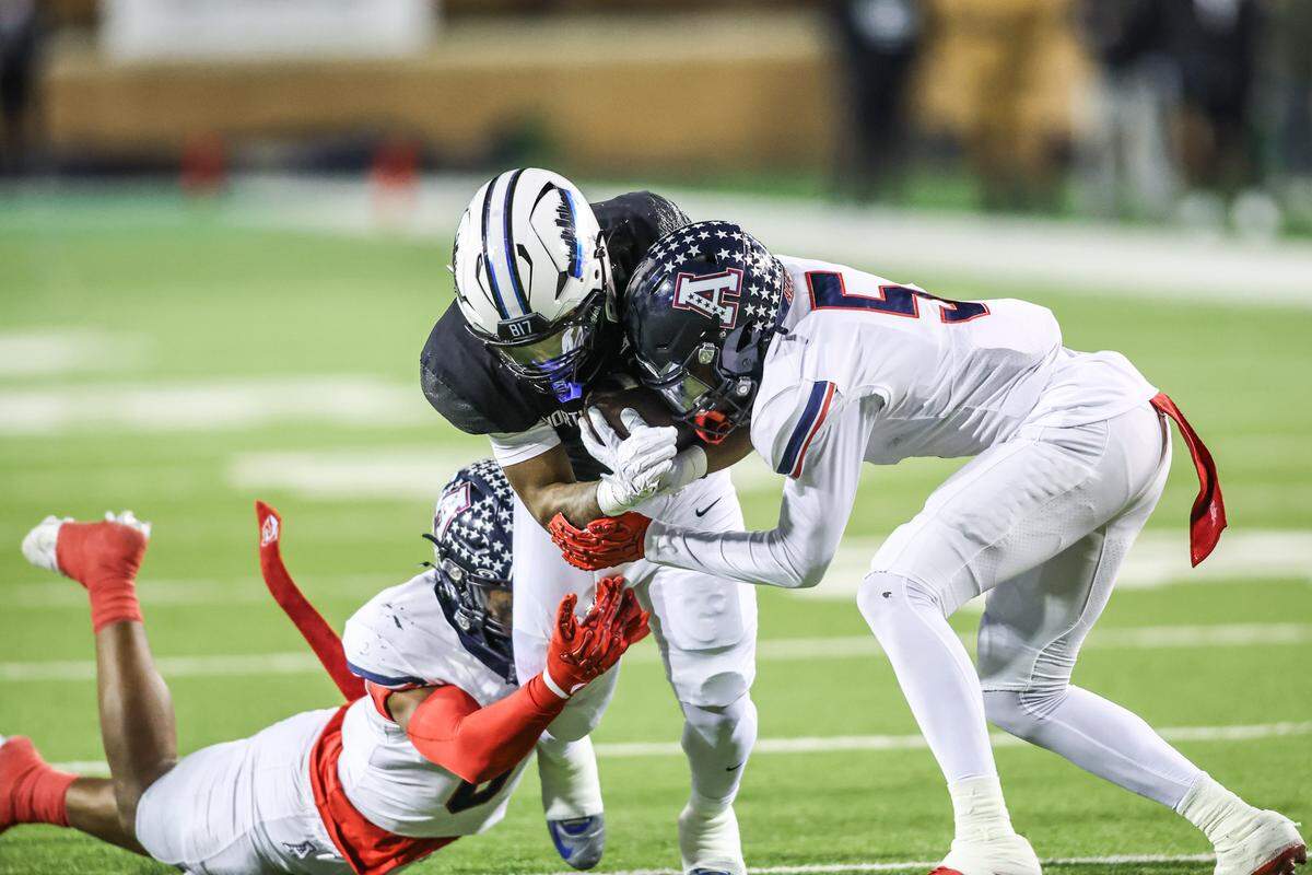 North Crowley running back G’Yrell Smith is tackled by Allen’s Kai Wheaton (5) and Trey Roberson during the Class 6A Division I regional final Friday, Dec. 5, 2025, at DATCU Stadium in Denton.
