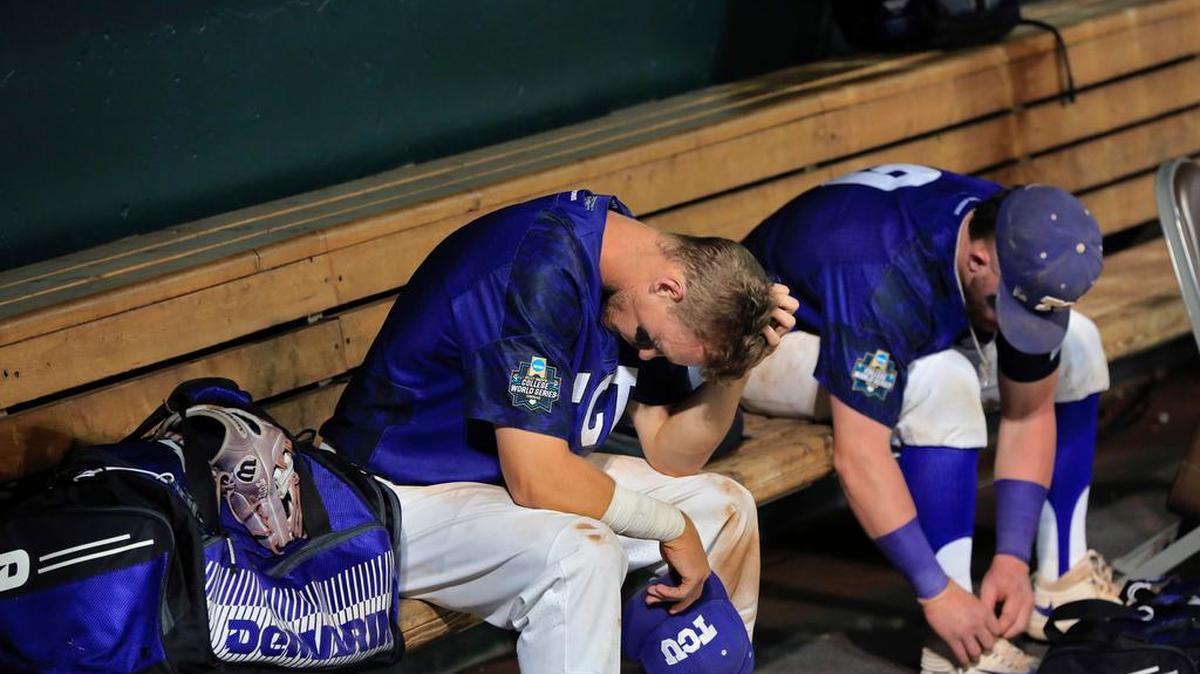 TCU’s Cam Warner, right, reacts with the TCU dugout after losing to Florida in their College World Series elimination game Saturday in Omaha, Neb.