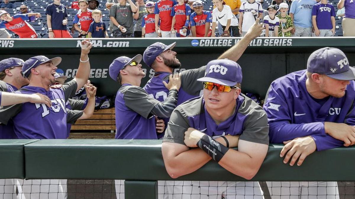 TCU players take photos as they wait in the dugout for Florida to finish their practice in Omaha, Neb., Friday, June 16, 2017. Florida is playing TCU in the NCAA baseball College World Series on Sunday.