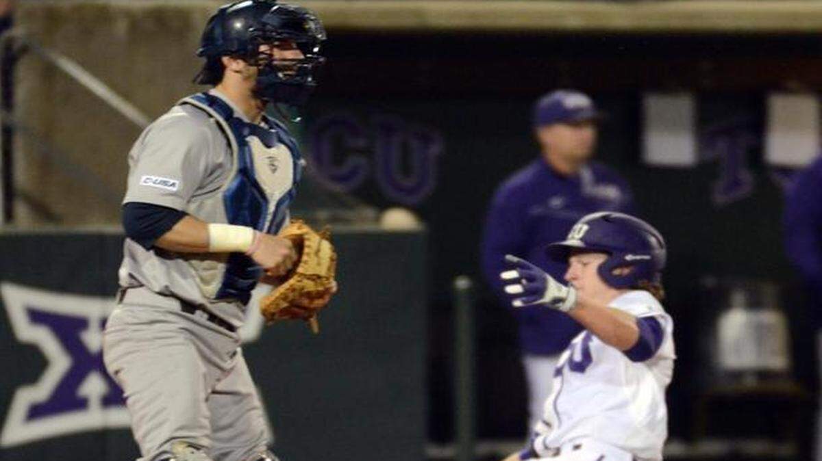 
Cody Jones scores in front of Rice catcher Hunter Kopycinski to put TCU up 3-0 in the fourth inning.



