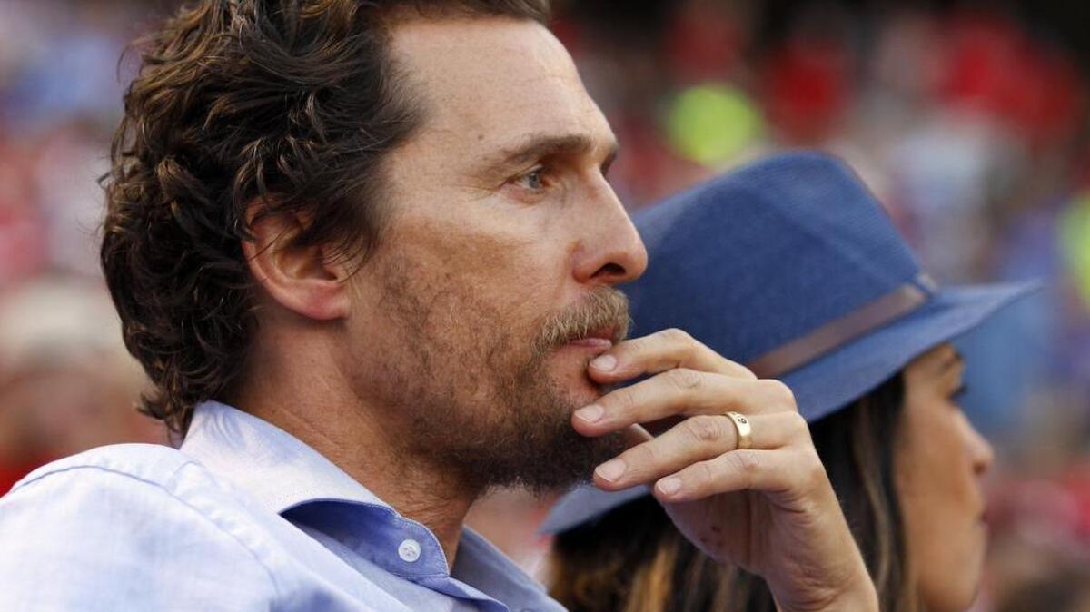 Matthew McConaughey gave a passionate defense of Texas coach Charlie Strong when a reporter stopped him on the street.