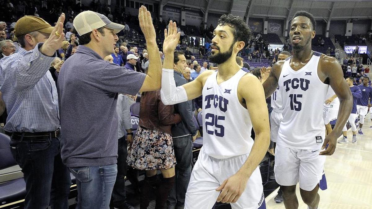 TCU guard Alex Robinson (center) and forward JD Miller celebrate with fans following a victory against Texas Tech at Schollmaier Arena on Feb. 7. Both players return from a 24-15 team.