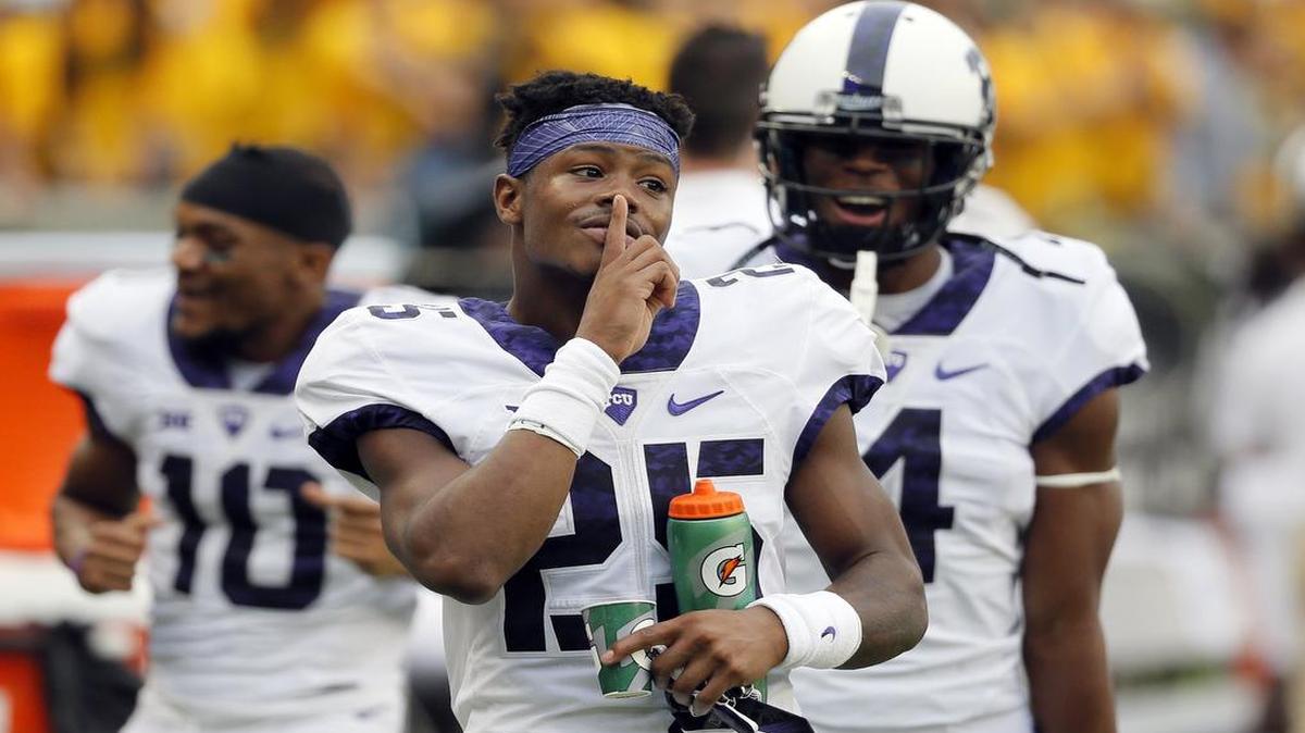 TCU receiver KaVontae Turpin gestures with a finger to his lips after teammate Ranthony Texada’s 28-yard interception return for a touchdown in the second quarter Saturday against Baylor. The score gave the Horned Frogs a 31-7 lead in a game they eventually won 62-22.