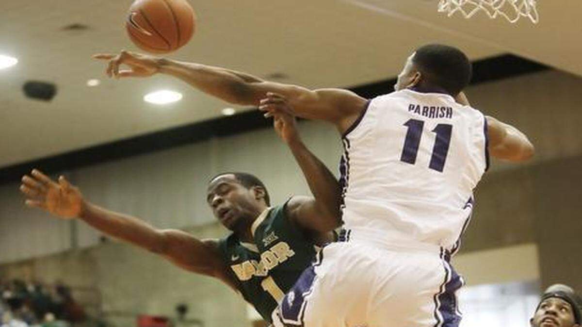 
TCU forward Brandon Parrish blocks a layup attempt by Baylor guard Kenny Chery during the teams’ meeting Jan. 10. Baylor won 66-59 in overtime. 
