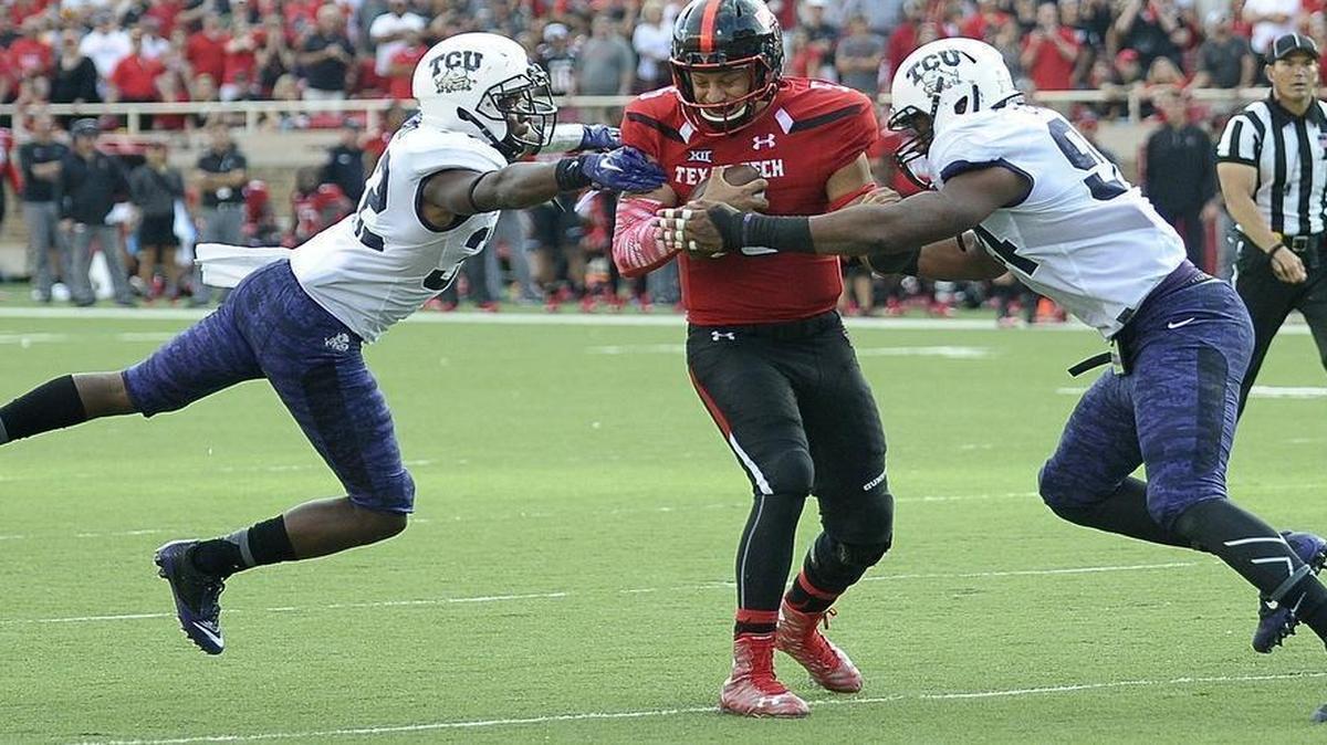 
TCU’s Travin Howard (left) and Josh Carraway close in on Texas Tech quarterback Patrick Mahomes. Howard, a sophomore safety-turned-linebacker, had the only sack of the game -- the first allowed by Texas Tech this season.
