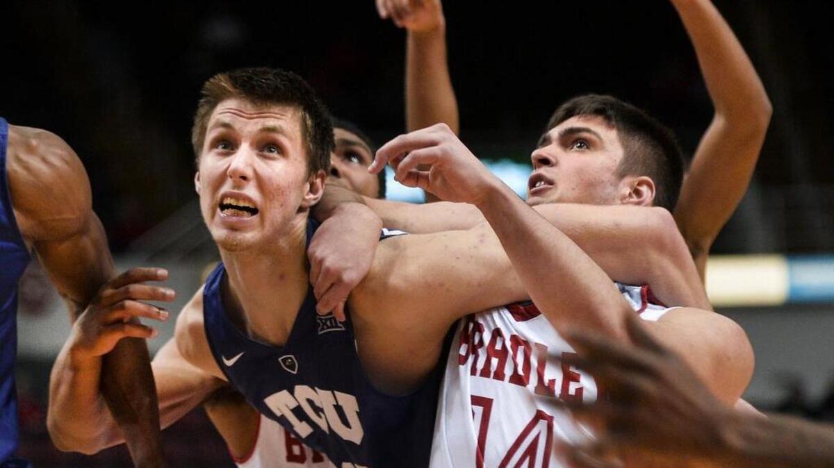 TCU’s Vladimir Brodziansky tangles with Bradley’s Peter Hanley in Wednesday night’s game in Peoria, Ill. Brodziansky contributed 10 points to the Horned Frogs’ 53-49 victory.