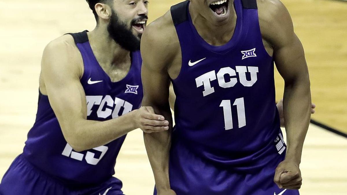 TCU guard Brandon Parrish (11) celebrates with Alex Robinson after the Horned Frogs’ 85-82 upset of top-ranked Kansas in the Big 12 conference tournament. Parrish, a recent graduate, is on a goodwill tour of the Far East on a team comprised of former college players.