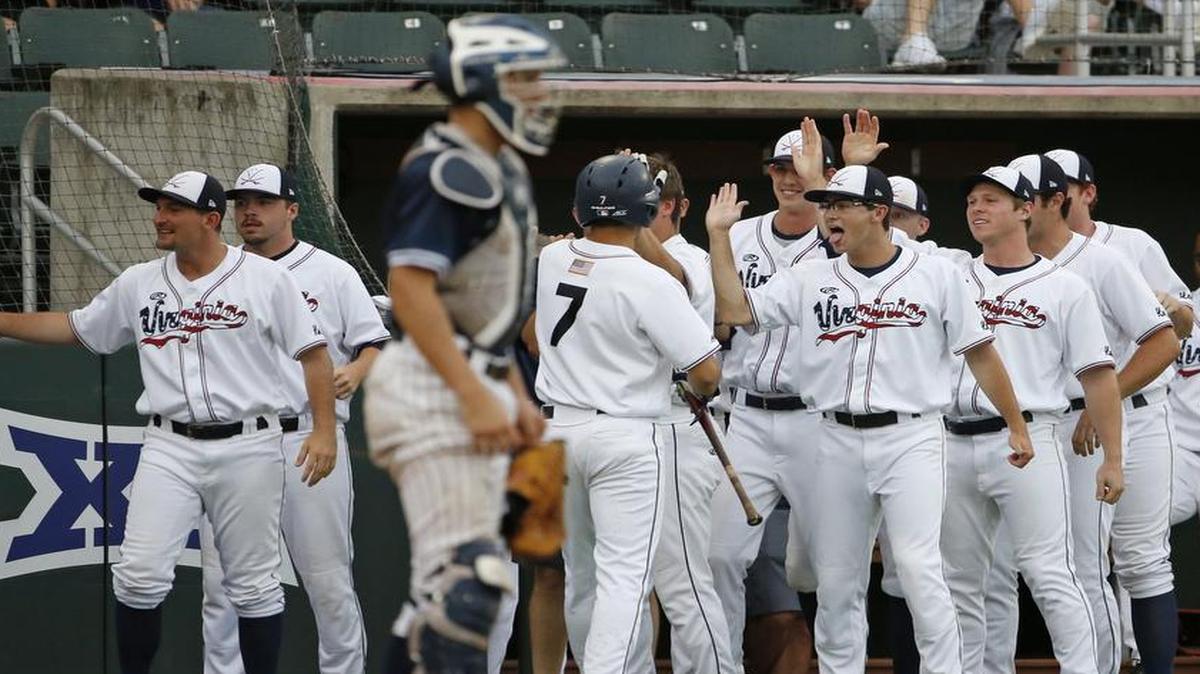 Virginia center fielder Adam Haseley (7) is congratulated in the dugout after scoring in the fifth inning on designated hitter Robbie Coman’s double.