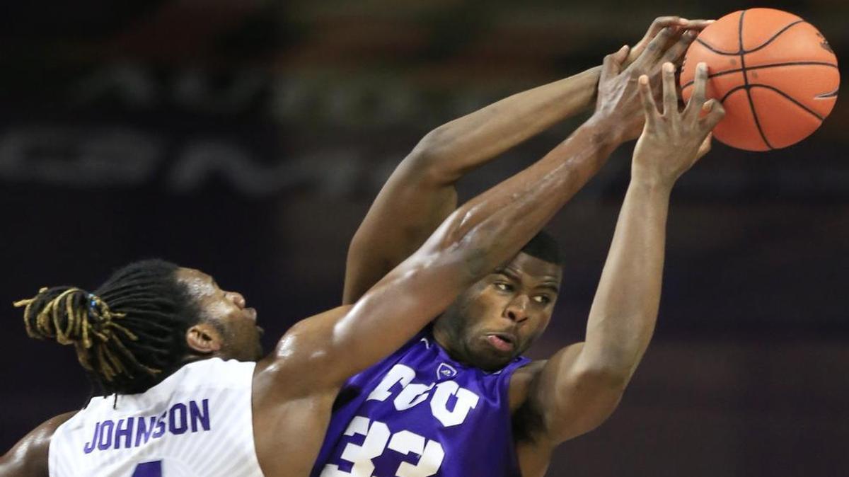 TCU forward Chris Washburn battles for control of a rebound against Kansas State’s D.J. Johnson during second-half action Wednesday in Manhattan, Kan. Washburn finished with four rebounds and seven points for the Horned Frogs.