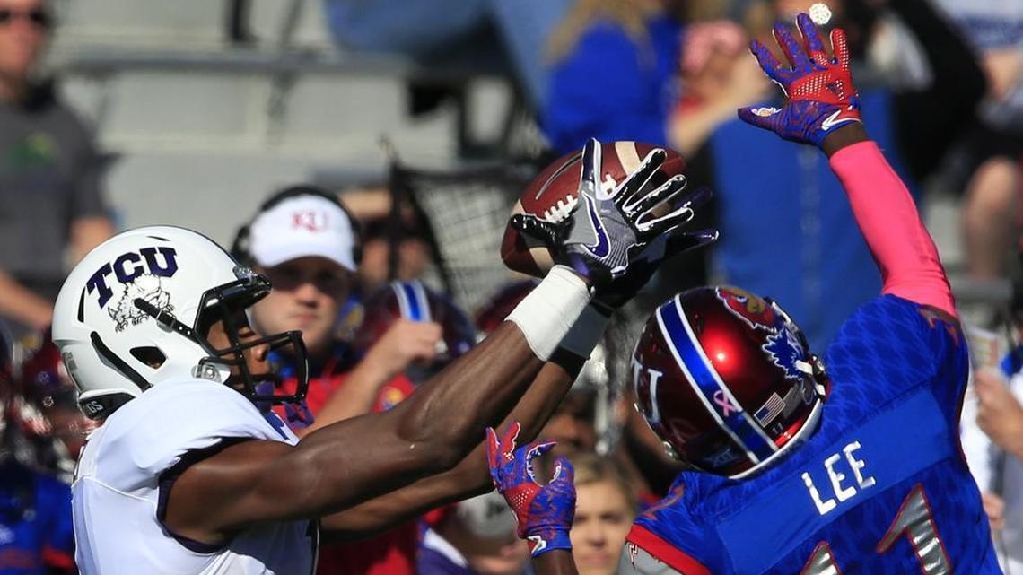 TCU wide receiver Emanuel Porter, left, catches a pass over Kansas linebacker Mike Lee during the Horned Frogs’ 24-23 win in Lawrence, Kan., a year ago.