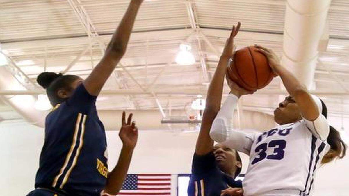 
TCU guard Donielle Breaux (33) tries to get off a shot over West Virginia forward Kayla Montgomery (L) and guard Jessica Morton during the first half of Tuesday’s game.

