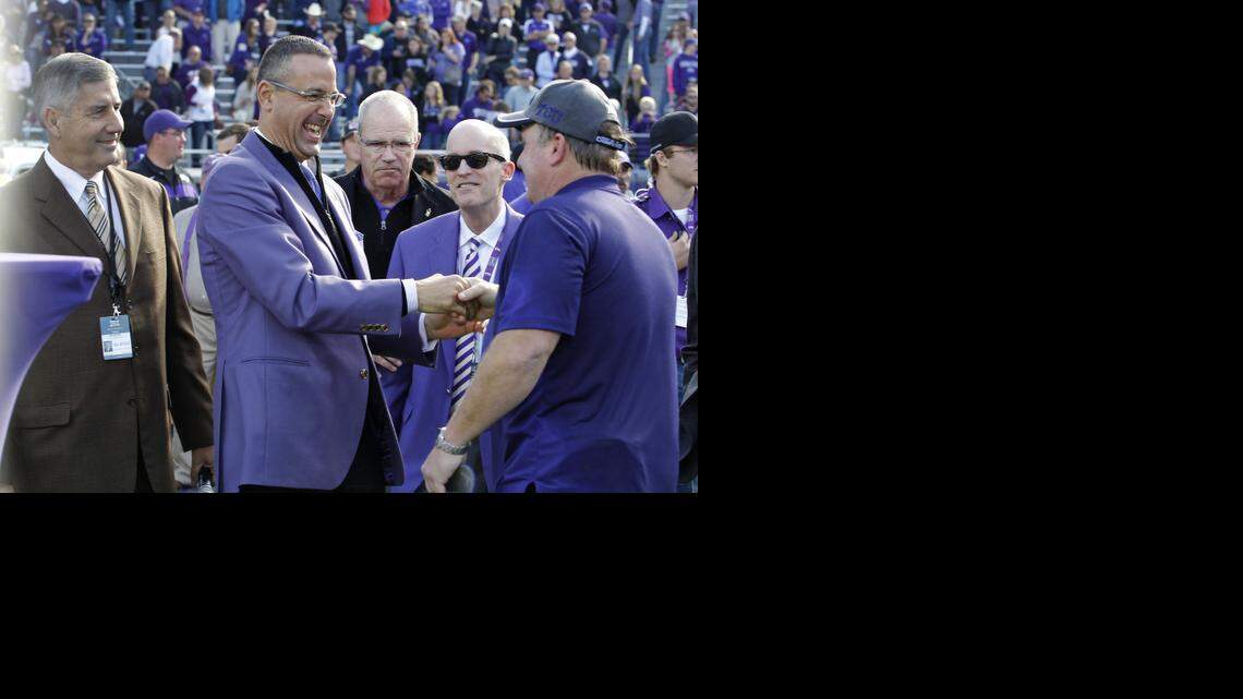 
TCU athletic director Chris Del Conte, center, shaking hands with coach Gary Patterson after Saturday’s victory, said he did not think the Big 12 needed a title game to help move its champion into playoff position.


