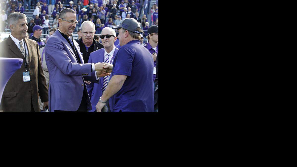 
TCU athletic director Chris Del Conte, center, shaking hands with coach Gary Patterson after Saturday’s victory, said he did not think the Big 12 needed a title game to help move its champion into playoff position.


