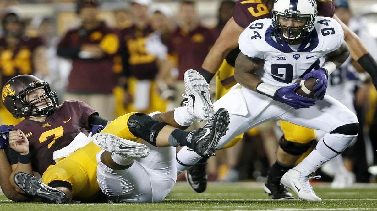 
TCU defensive end Josh Carraway comes up with a fumble caused by a sack by Terrell Lathan against Minnesota’s Mitch Leidner. The first-quarter takeaway set up a touchdown for a 10-0 lead.
