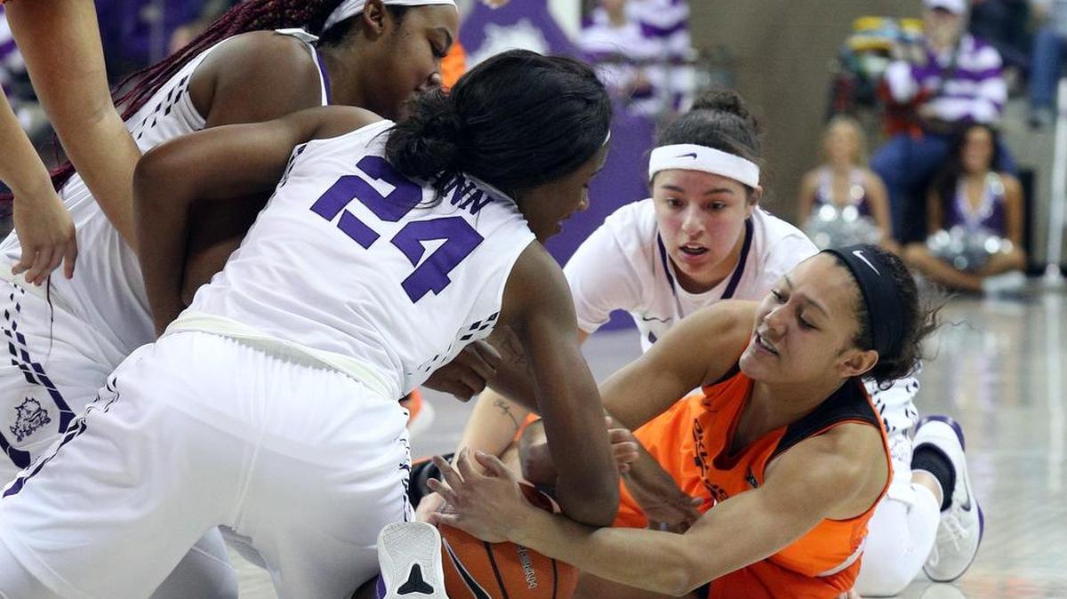 A trio of TCU players surround Oklahoma State’s Braxtin Miller in pursuit of a loose ball during Wednesday’s Big 12 women’s game.