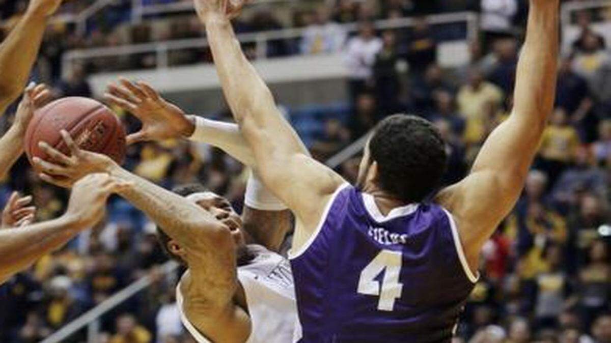 
Amric Fields, right, and the Frogs suffered a hard-fought 86-85 overtime loss Saturday against Daxter Miles and West Virginia.



