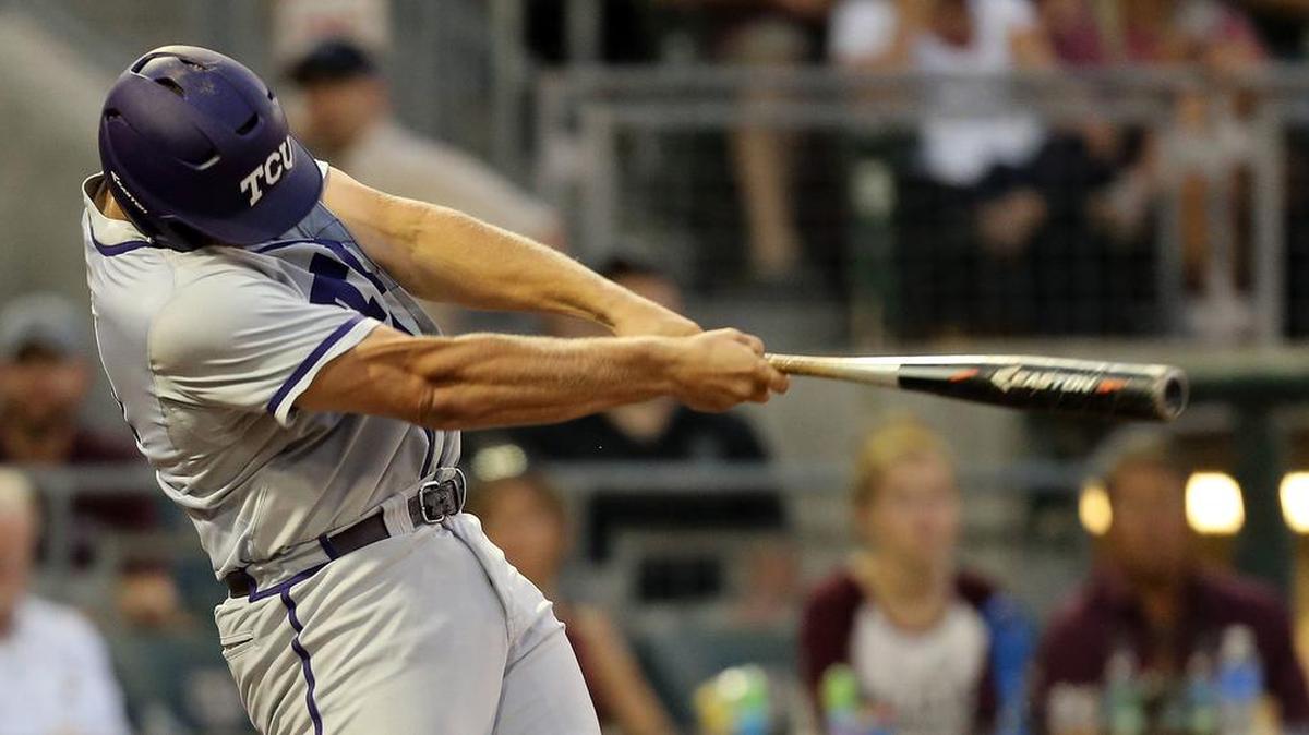 TCU’s Luken Baker follows through on a swing for a base hit against Texas A&M in an NCAA Super Regional tournament game June 12 in College Station. The designated hitter is one of five TCU players who has received a second set of preseason All-America honors.