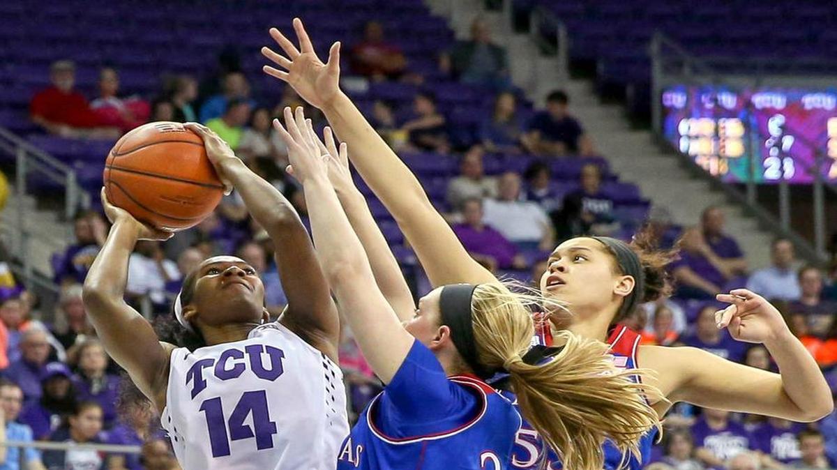 Zahna Medley, who passed Sandora Irvin to become TCU’s all-time leading scorer, shoots over Lauren Aldridge and Tyler Johnson on the way to scoring 21 points.