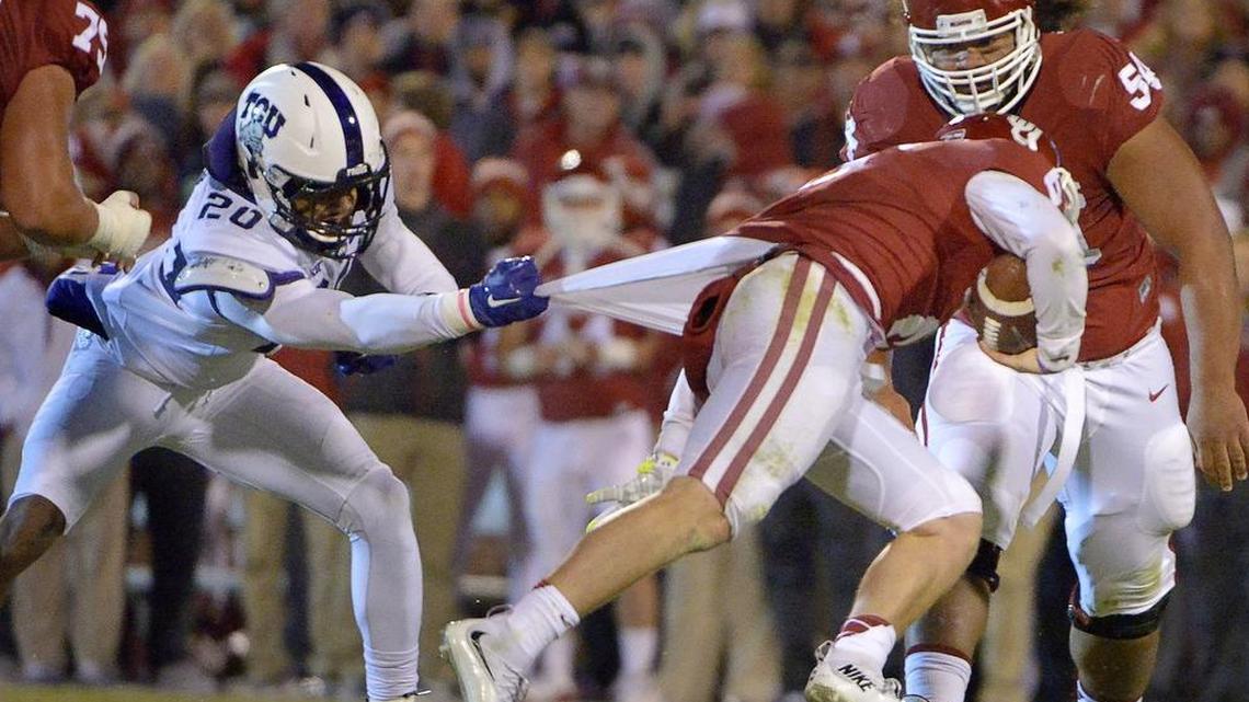 TCU linebacker Montrel Wilson drags down Oklahoma quarterback Baker Mayfield by his shirt for a tackle in the 2015 game at Norman.