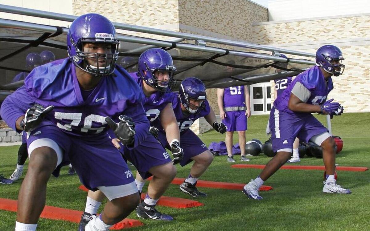 Offensive tackle Sam Awolope, left, and other TCU linemen work out in spring practice in March. The Horned Frogs added their first true offensive tackle recruit late Saturday with a recruiting commitment from 6-foot-5 Kris Dike of Van in East Texas.