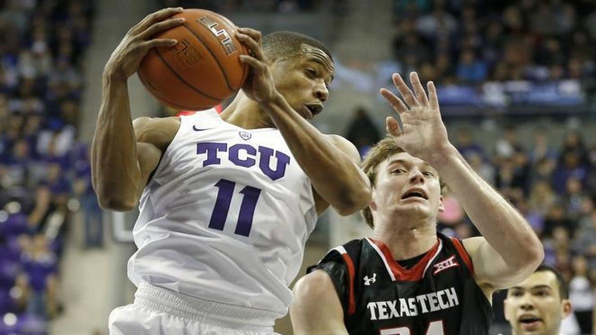 TCU guard Brandon Parrish, an Arlington Seguin product, pulls down a rebound against Texas Tech’s Matthew Temple on Monday at Schollmaier Arena.