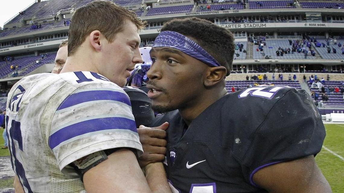 TCU running back Kyle Hicks (right) congratulates Kansas State quarterback Jesse Ertz after the Wildcats’ victory at Amon G. Carter Stadium on Dec. 3.