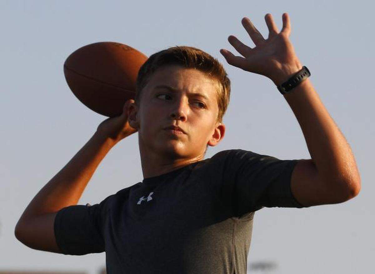 Ken Seals, 13, works out at Timber Creek High School on July 25, 2014. He had just won the National Football Academy Quarterback Competition in Ohio.