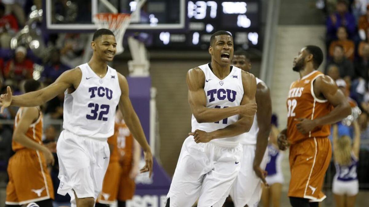 TCU guard Brandon Parrish (right) reacts in celebration with teammate Karviar Shepherd as the horn sounds in the Horned Frogs’ 58-57 victory against Texas on Saturday. Parrish scored 15 points on 5-of-6 shooting from 3-point range.