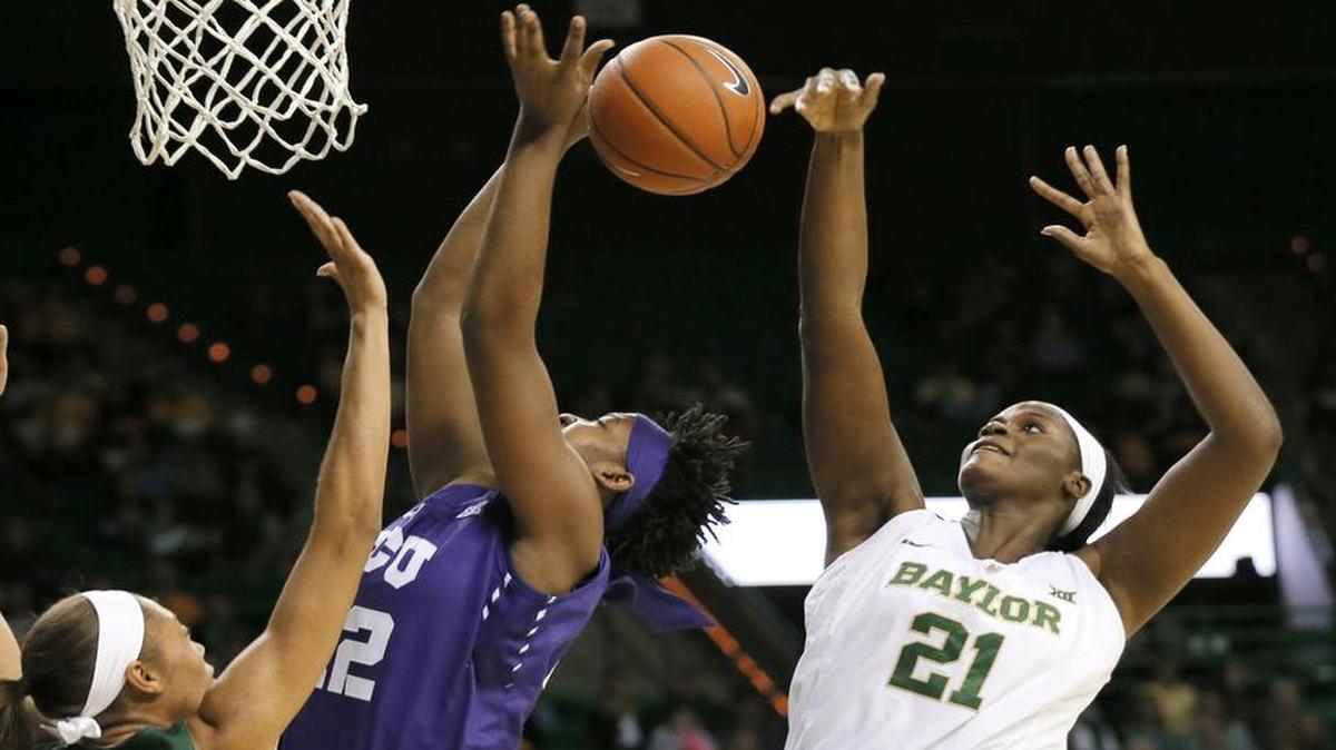 Baylor center Kalani Brown swats away a shot attempt by TCU’s Jordan Moore. Brown had six of Baylor’s 13 blocked shots on Wednesday night as the second-ranked Bears improved to 16-1 while TCU fell to 8-8.