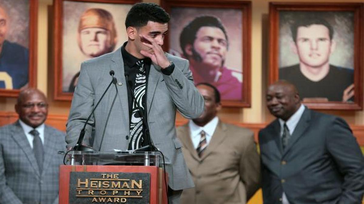 
Oregon quarterback Marcus Mariota tears up while speaking after he was named college football’s best player during the Heisman Trophy presentation in New York on Saturday,. 
