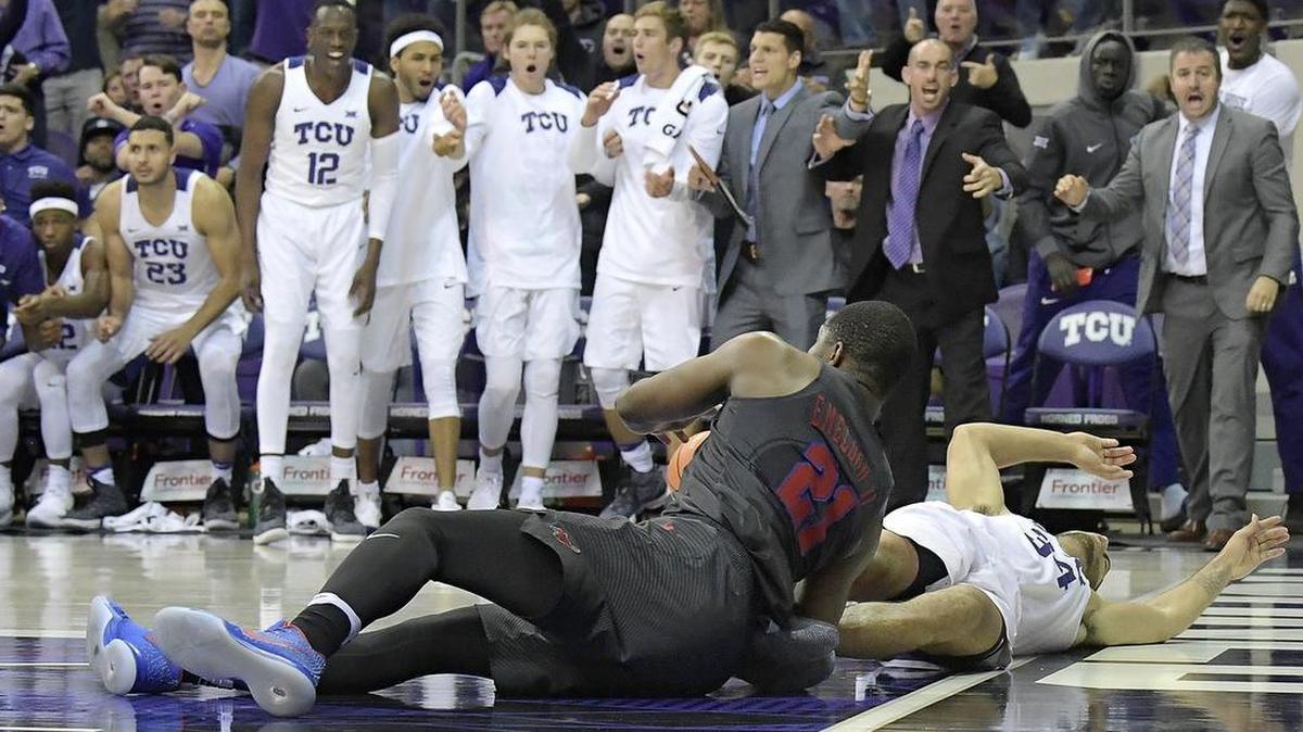 TCU players and coaches react as SMU’s Ben Emelogu and TCU’s Kenrich Williams fall to the court following an intentional foul by the SMU player in the second half of Tuesday night’s game at Schollmaier Arena.
