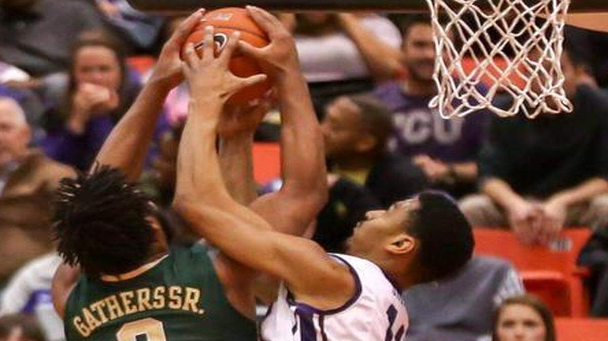 
TCU center Karviar Shepherd, right, fights for a rebound with Baylor forward Rico Gathers during the first half Saturday  at the Wilkerson Greines Athletic Center. 
