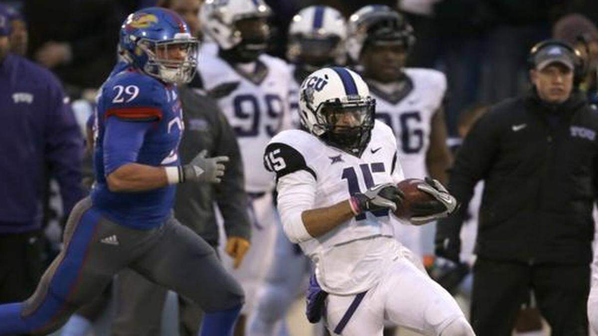 
Cameron Echols-Luper makes a cut behind blockers en route to a touchdown return of a punt against Kansas. Luper, who won the long jump championship at the Big 12 indoor meet on Saturday, is moving from receiver to cornerback this season.

