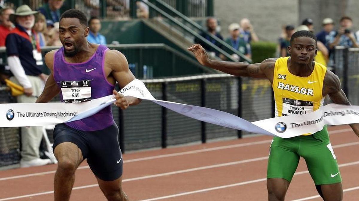 
Tyson Gay, left, hits the tape ahead of Baylor’s Trayvon Bromell to win the 100-meter final  in Eugene, Ore.
