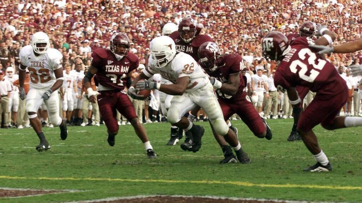Texas running back Cedric Benson scores a touchdown during a game against Texas A&M. The two rivals haven’t played since 2011 but could meet in a bowl game this year.