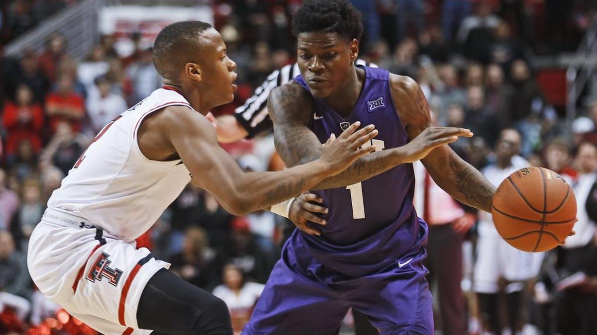 TCU guard Chauncey Collins looks to drive against Texas Tech’s Devon Thomas in Wednesday night’s game at the Big 12 tournament. Collins scored 19 points in TCU’s 67-62 victory.