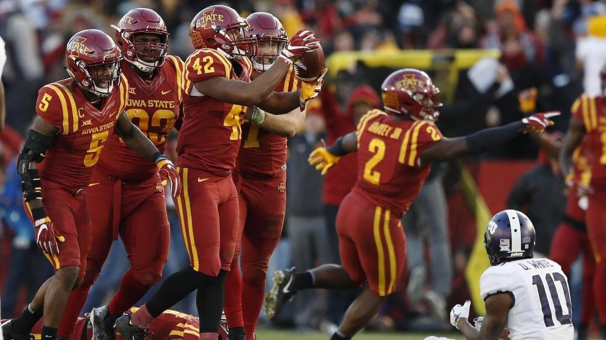 Iowa State linebacker Marcel Spears Jr. (42) celebrates with teammates after intercepting a pass in front of TCU wide receiver Desmon White (10) in the second half Saturday.