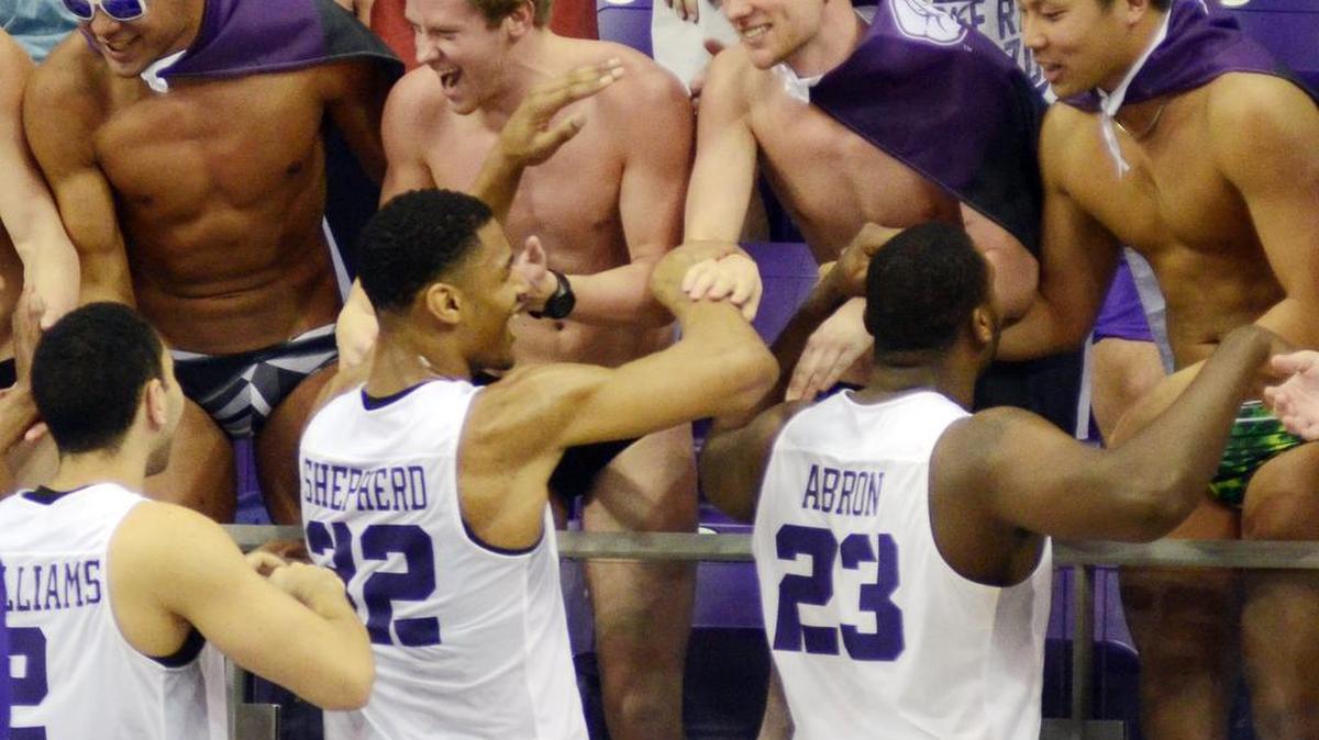 TCU players Michael Williams, Karviar Shepherd and Devonta Abron celebrate with fans in swim gear after Saturday’s 75-63 victory against Tennessee.