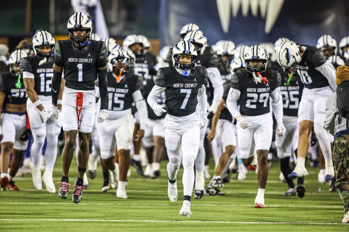 The North Crowley football team runs onto the field before kickoff against Allen in the Class 6A Division I regional final Friday, Dec. 5, 2025, at DATCU Stadium in Denton.