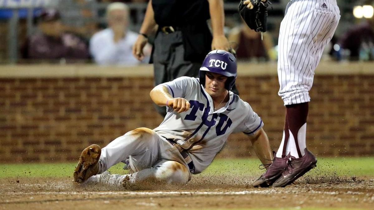 TCU’s Josh Watson slides at home plate to score on a passed ball in the fifth inning of Game 3 of a Super Regional series at Texas A&M on Sunday. The play tied the game, and TCU went on to a 4-1 victory to advance to the College World Series.