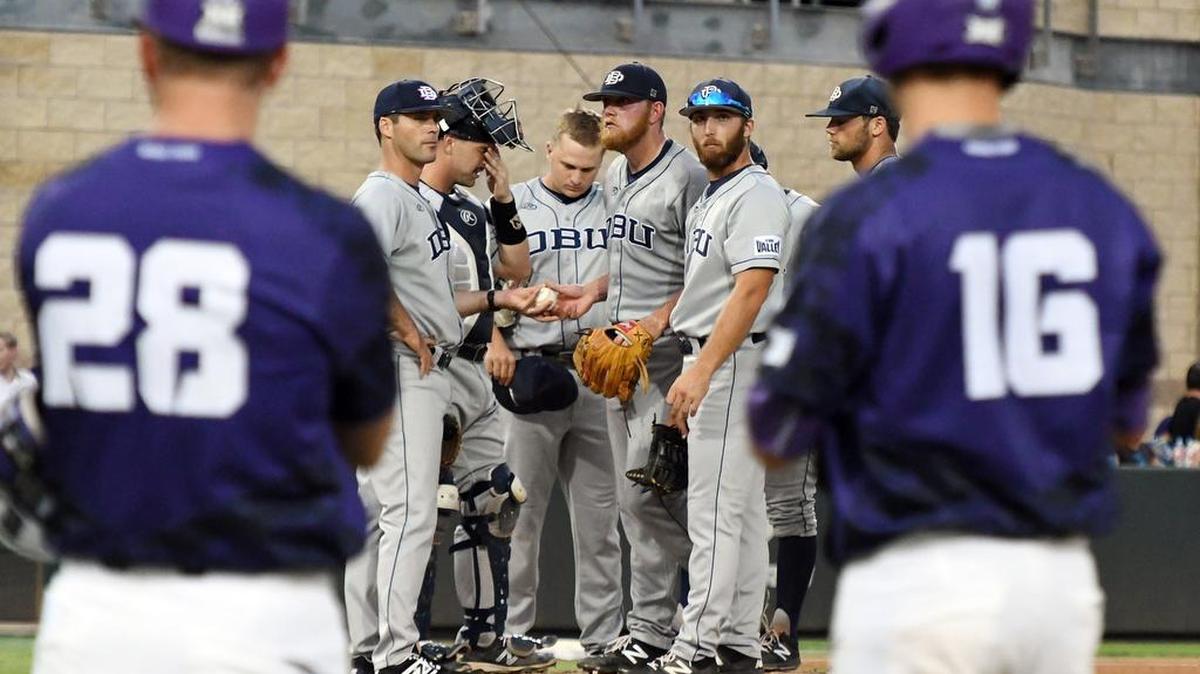 TCU first base coach Zach Etheredge and baserunner Connor Wanhanen wait as Dallas Baptist makes a pitching change in the third inning of the Fort Worth Regional championship game on Monday at Lupton Stadium.
