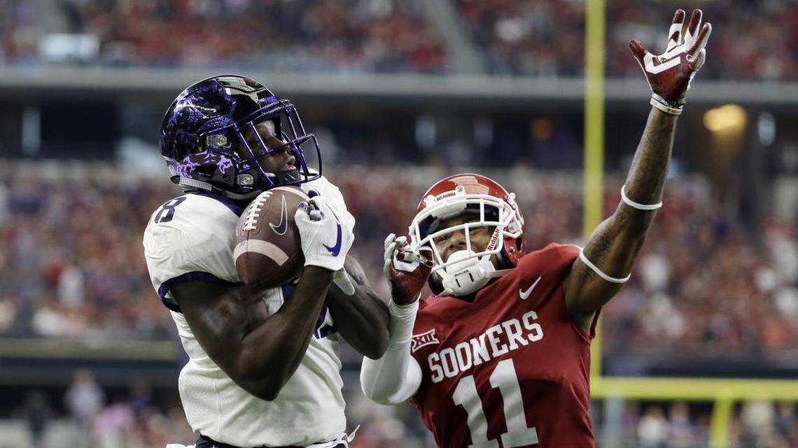 TCU wide receiver Jalen Reagor catches a touchdown pass in front of Oklahoma cornerback Parnell Motley (11) in the first half of the Big 12 Conference championship on Saturday.