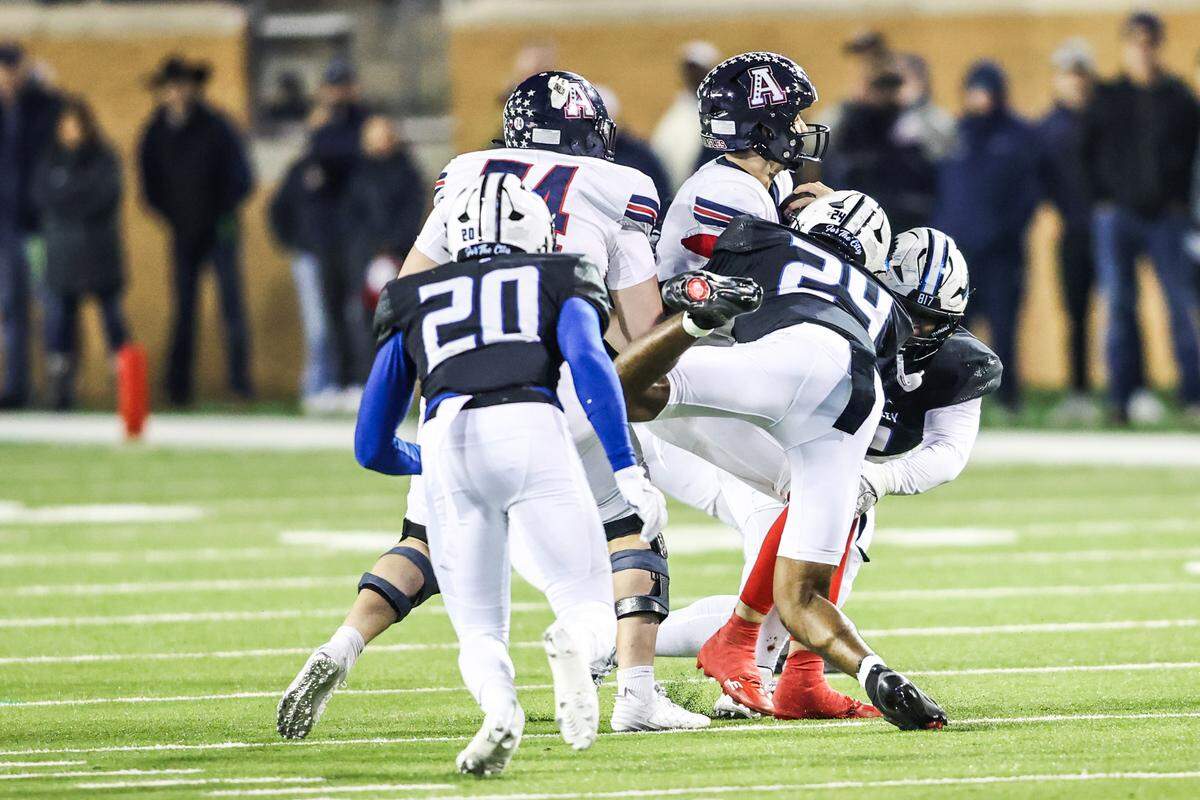 North Crowley’s Jurwone Irvin (24) sacks the Allen quarterback during the Class 6A Division I regional final Friday at DATCU Stadium in Denton.