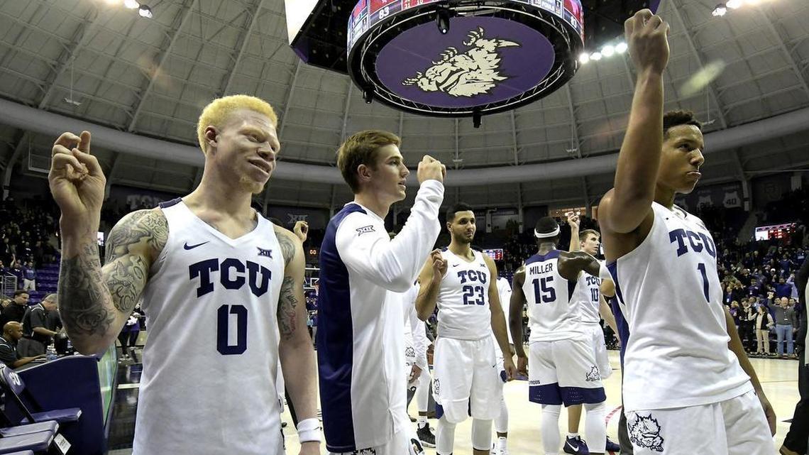 TCU guard Jaylen Fisher (left), forward Clayton Crawford (center) and guard Desmond Bane salute and sing the school song following a 94-83 victory over SMU on Dec. 5 at Schollmaier Arena. The victory was the Frogs’ 14th straight in a streak that has since reached 15.