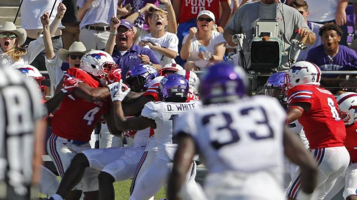 TCU wide receiver Jalen Reagor (18), in the middle of the scrum, hauls in a Hail Mary pass at the end of the second quarter for a 71-yard touchdown against SMU at Amon Carter Stadium in Fort Worth, Texas, on Saturday, Sept. 16, 2017.
