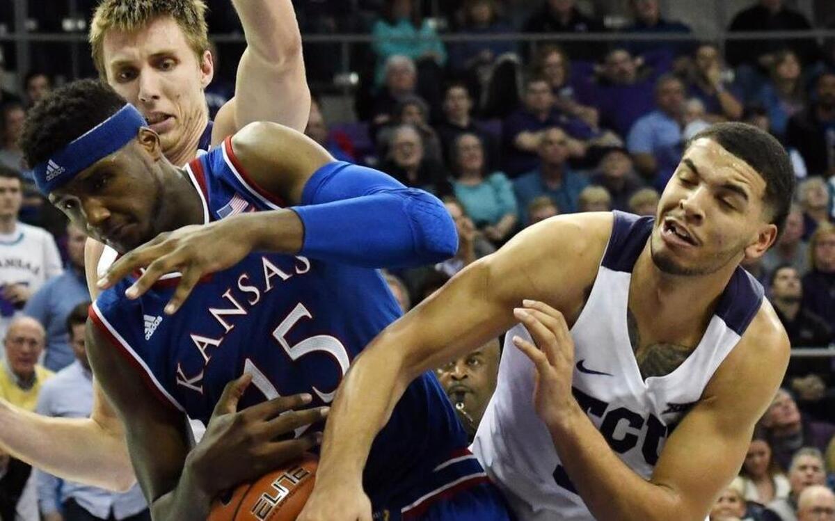 TCU’s Vladimir Brodziansky, left, and Kenrich Williams, right fight for a rebound with Kansas’ Carlton Bragg Jr. during the second half of Friday’s December 30, 2016 men’s basketball game at Schollmaier Arena, in Fort Worth, Texas. Kansas went on to win 86-80. Brodziansky had a career high 28 points.