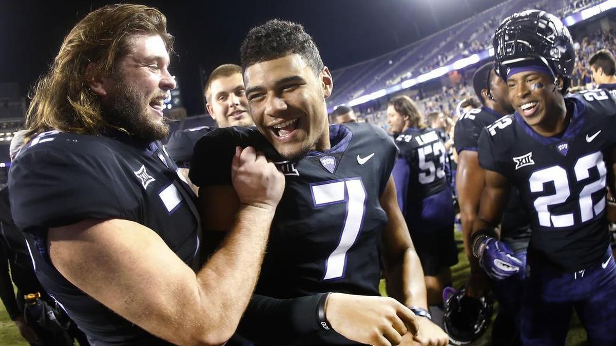 TCU quarterback Kenny Hill celebrates with teammates after the Horned Frogs’ 43-0 victory over Kansas on Saturday at Amon G. Carter Stadium. He threw five touchdown passes, pushing his season total to 15.
