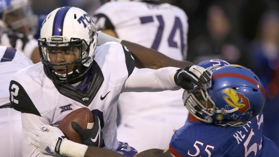 TCU quarterback Trevone Boykin avoids a tackle attempt by Kansas linebacker Michael Reynolds in a 2014 game at Lawrence, Kan. The Horned Frogs eventually won the contest34-30.